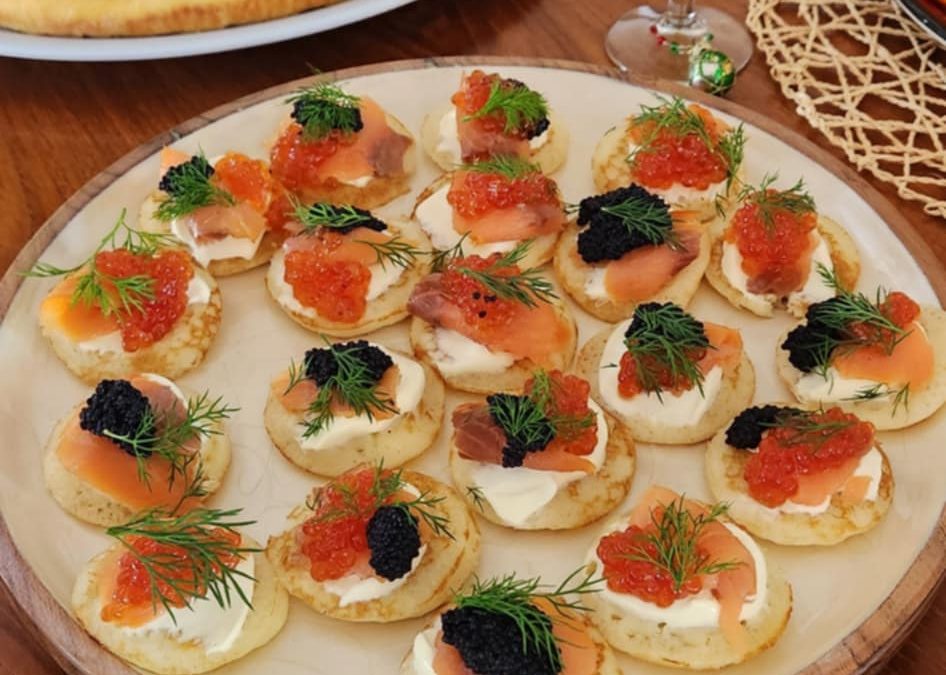 Christmas pancakes with crème fraîche, salmon, and caviar, representing indulgence and the challenges of body image after the holiday season.